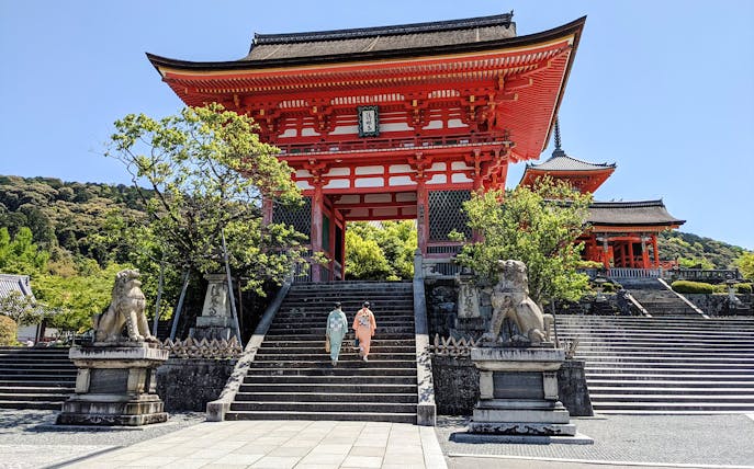 Two people in kimonos ascend steps at Kiyomizu-dera Temple, Kyoto.