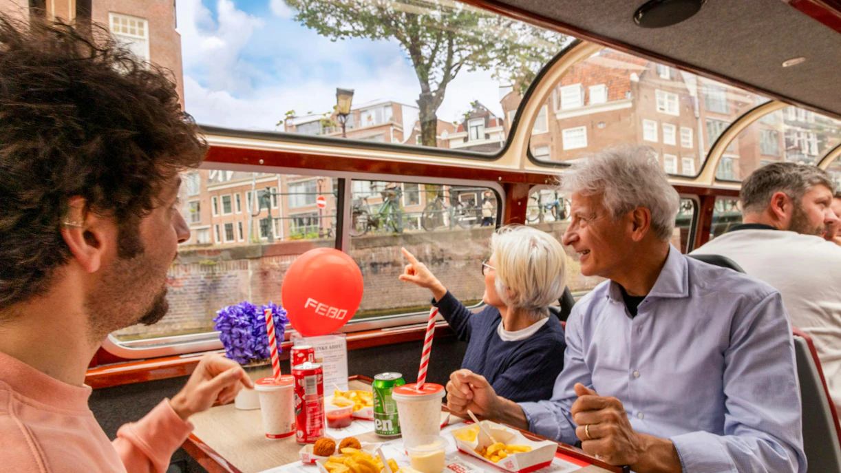 Guests enjoying FEBO snacks on an Amsterdam canal cruise.