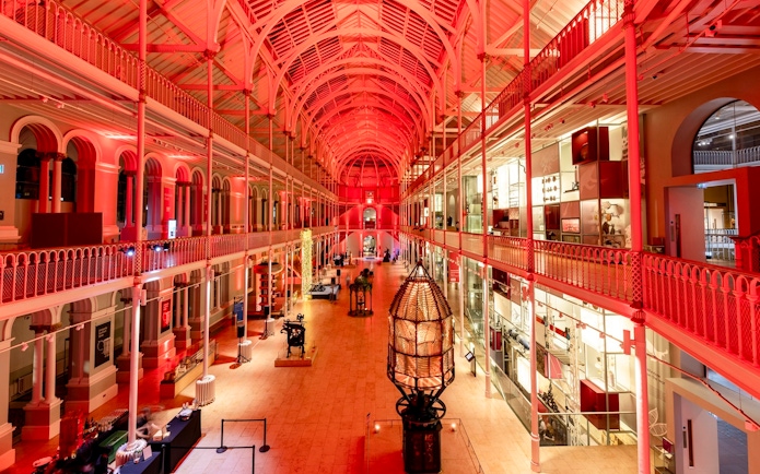 National Museum of Scotland interior with illuminated exhibits and arched ceiling.