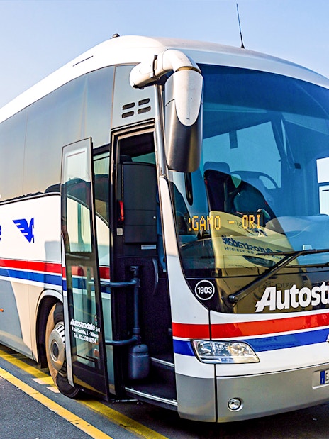 Airport transfer bus at Milan Airport terminal.