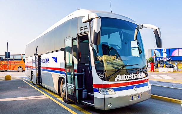 Airport transfer bus at Milan Airport terminal.