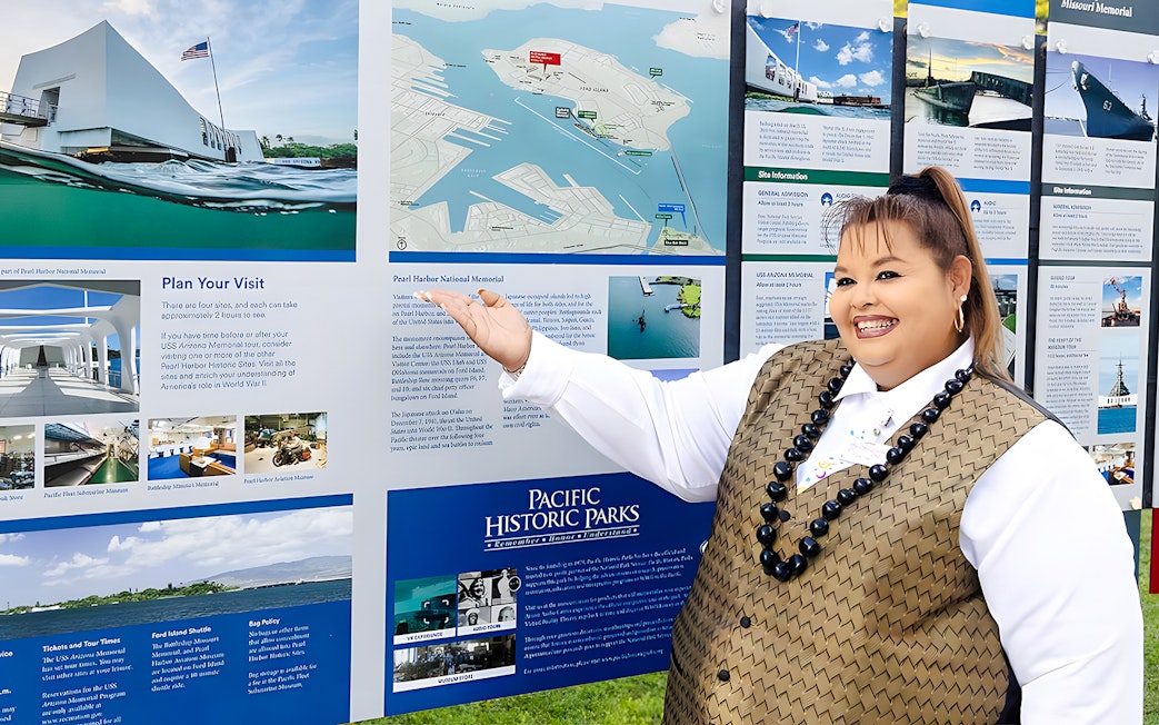 Tour guide on Royal Star Hawaii explaining Pearl Harbor National Memorial map.