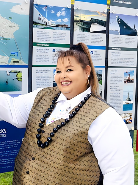 Tour guide on Royal Star Hawaii explaining Pearl Harbor National Memorial map.