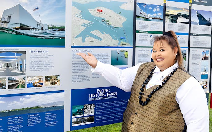 Tour guide on Royal Star Hawaii explaining Pearl Harbor National Memorial map.