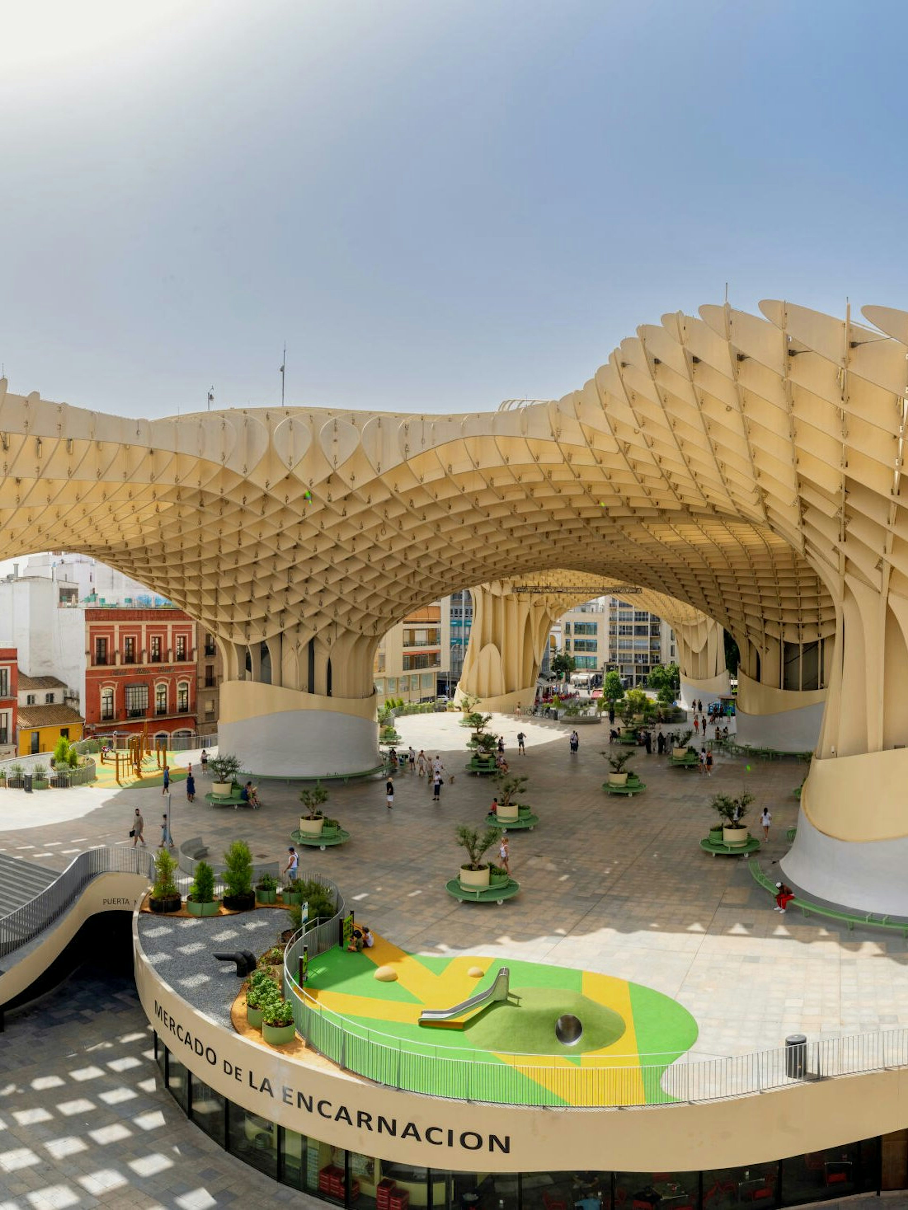 Visitors exploring the wooden structure of Setas de Sevilla, Spain.