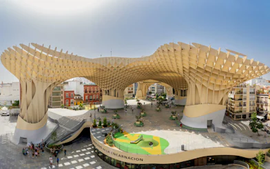 Visitors exploring the wooden structure of Setas de Sevilla, Spain.