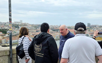 Group on a walking tour overlooking Porto cityscape.