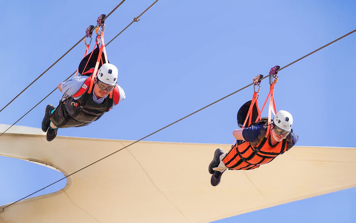 Ziplining adventure at Jais, UAE with two people in harnesses.
