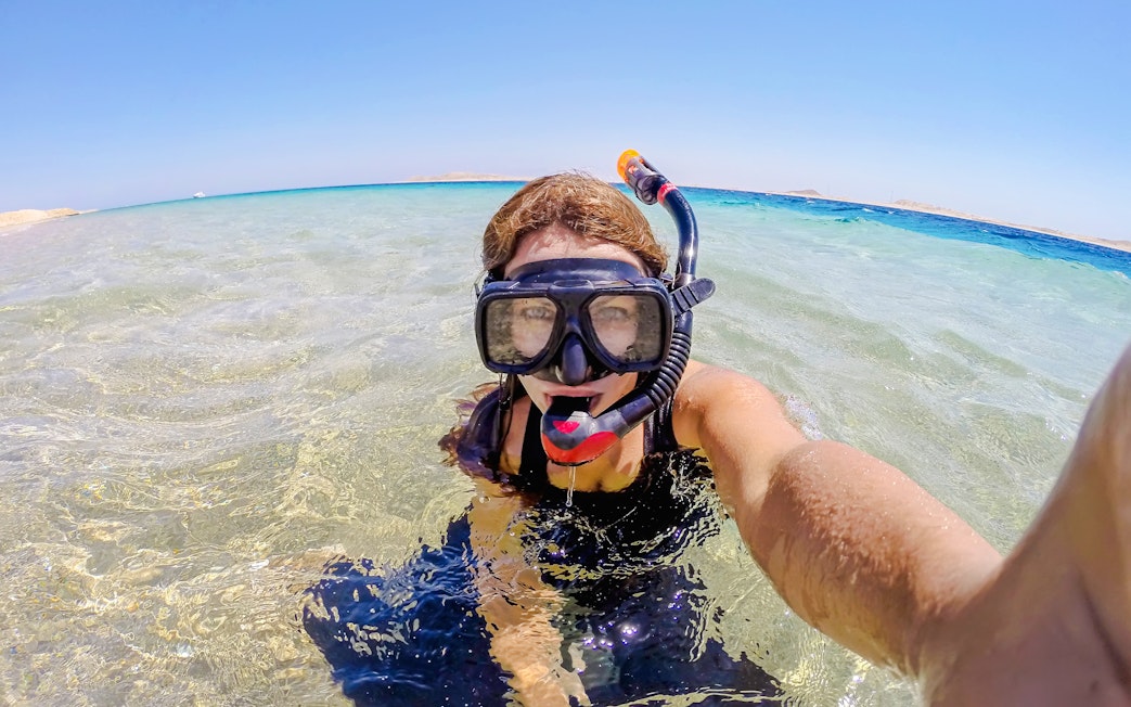 Woman snorkeling in clear waters at Ras Muhammad National Park, Egypt.