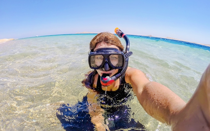 Woman snorkeling in clear waters at Ras Muhammad National Park, Egypt.