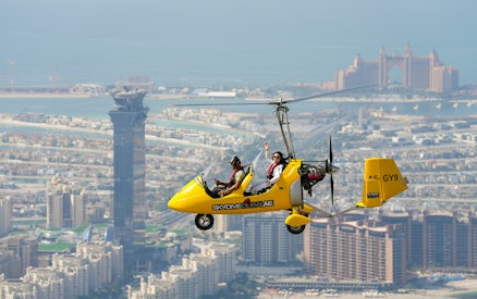 Gyrocopter flying over Dubai with Atlantis Hotel in the background.