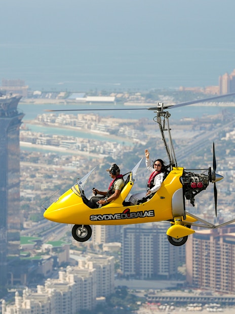 Gyrocopter flying over Dubai with Atlantis Hotel in the background.