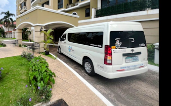 Shuttle van at hotel entrance for Tocumen Airport transfers, Panama City.
