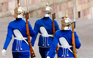Royal guards in blue uniforms marching at the Changing of the Guard ceremony, Royal Palace, Stockholm.