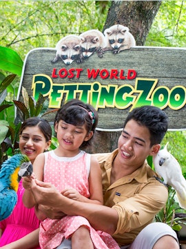 Family interacting with parrots at Lost World of Tambun Petting Zoo.