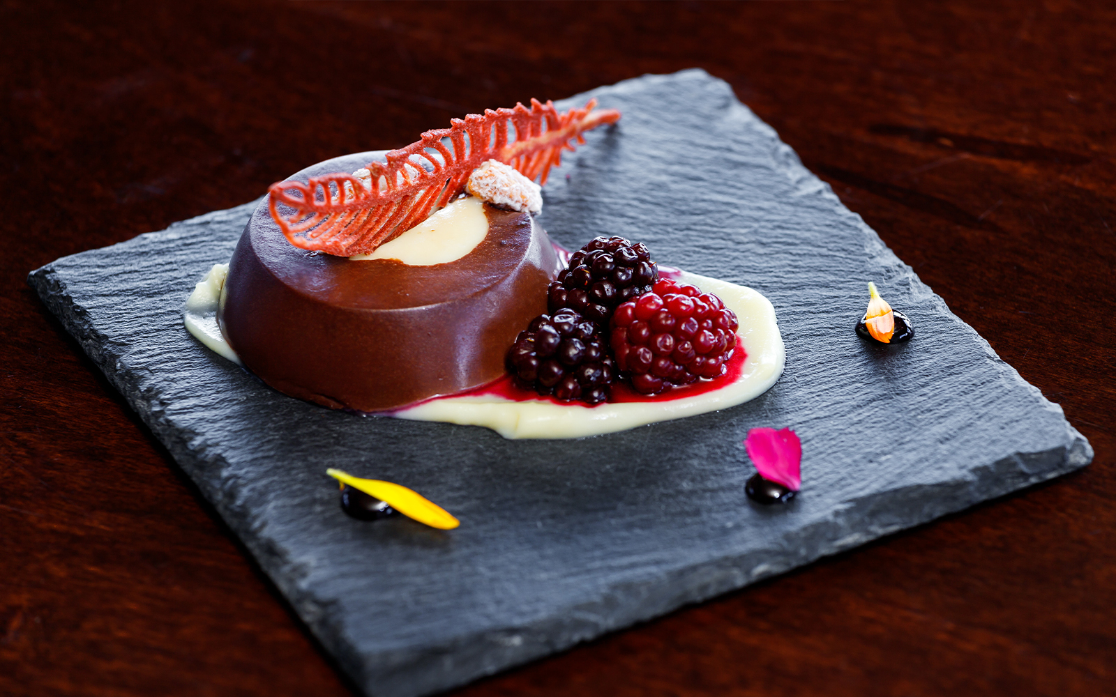 Chocolate dessert with berries on slate plate, served during Perito Moreno, Spegazzini & Upsala tour.