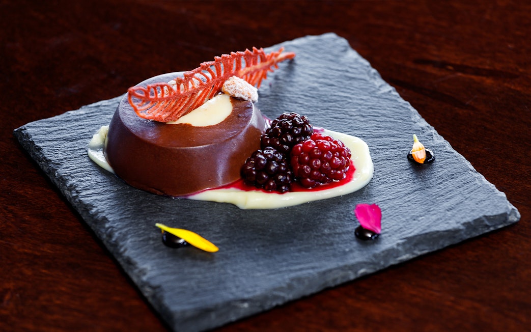 Chocolate dessert with berries on slate plate, served during Perito Moreno, Spegazzini & Upsala tour.