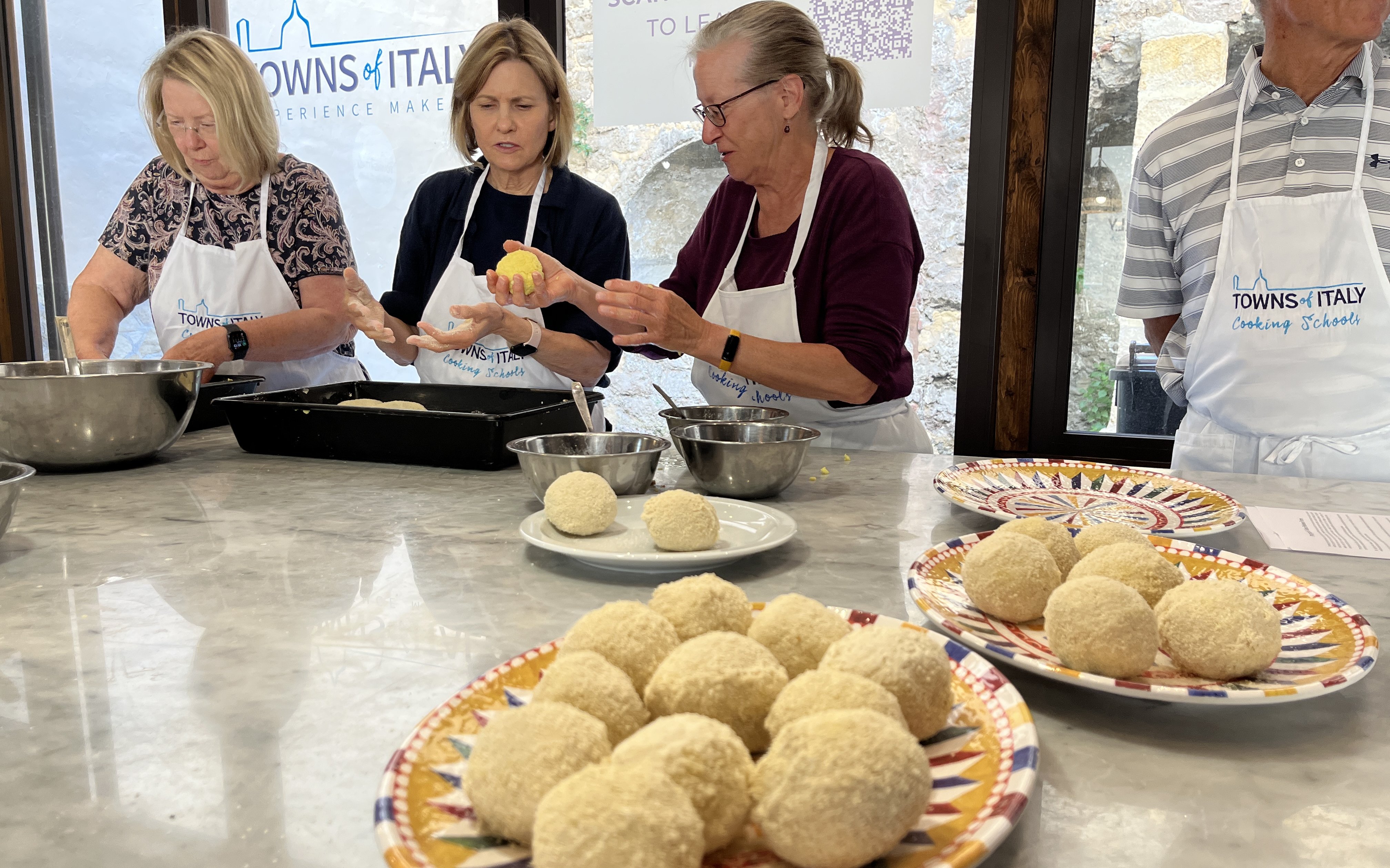 Participants preparing arancini during Palermo Market Tour and Cooking Class.
