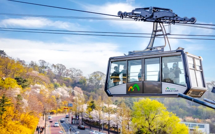 Namsan Cable Car over scenic spring landscape in Seoul, South Korea.