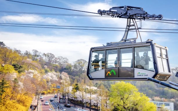 Namsan Cable Car over scenic spring landscape in Seoul, South Korea.