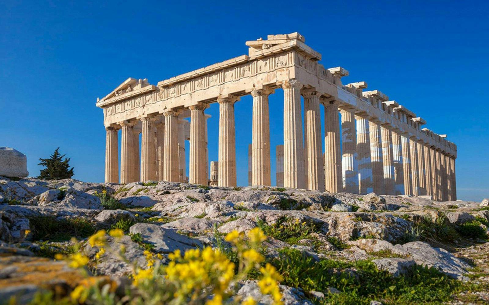 Parthenon temple on the Acropolis of Athens with clear blue sky.