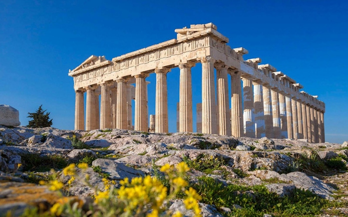 Parthenon temple on the Acropolis of Athens with clear blue sky.