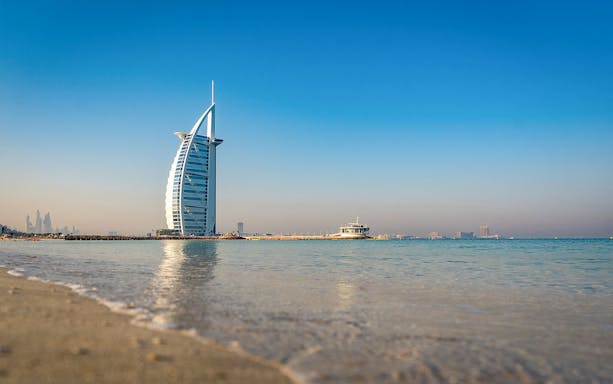 Kayaking near Burj Al Arab with city skyline in Dubai.