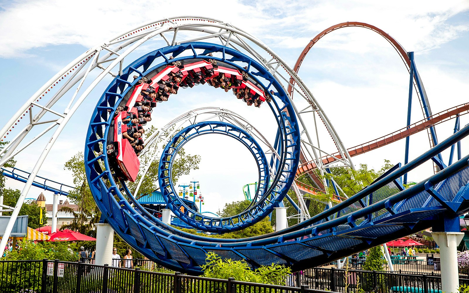 Corkscrew roller coaster looping at Cedar Point amusement park.