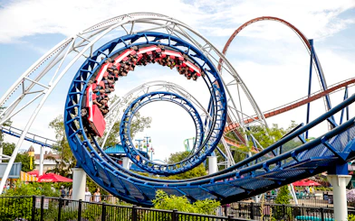Corkscrew roller coaster looping at Cedar Point amusement park.