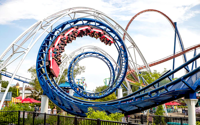 Corkscrew roller coaster looping at Cedar Point amusement park.