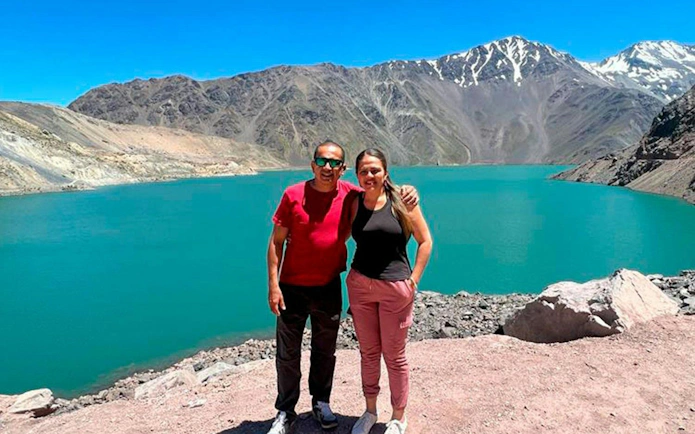 Visitors at Embalse El Yeso with Andes mountains in the background, Santiago tour.