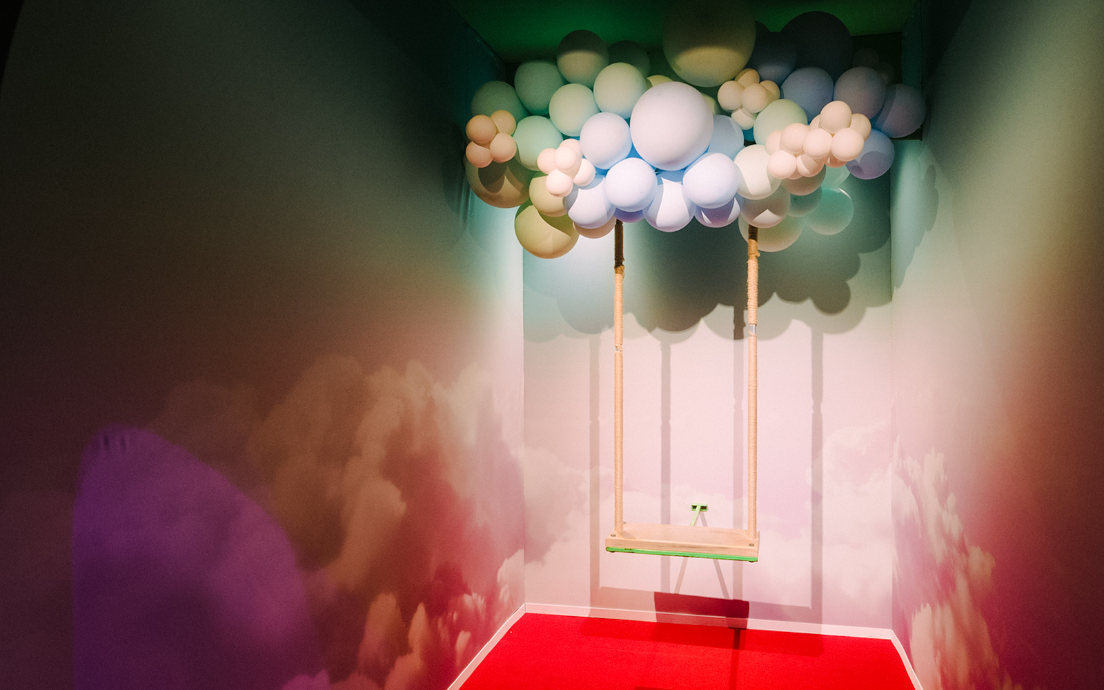 Swing under balloon cloud installation at Bubble Planet, Seattle.