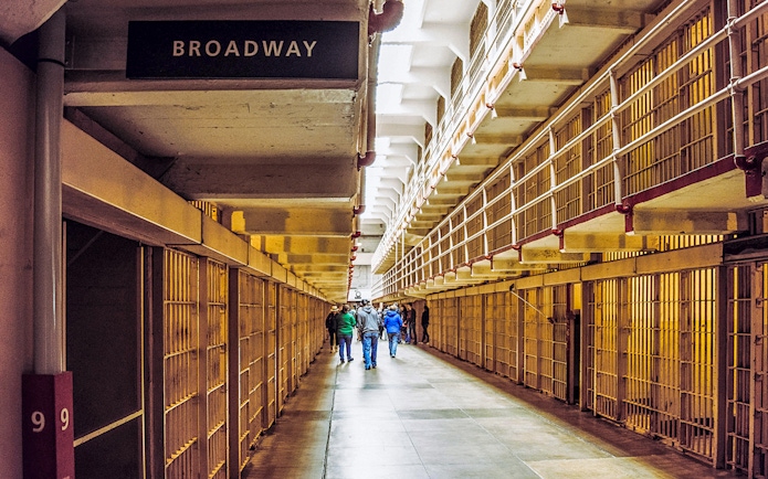 Alcatraz cell block corridor with visitors on Fisherman’s Wharf Walking Tour.