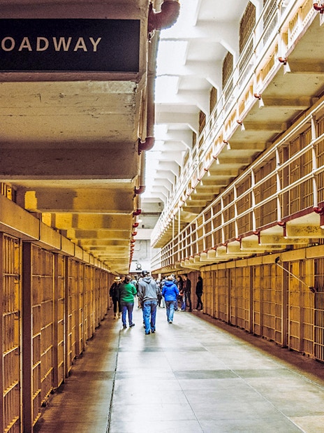 Alcatraz cell block corridor with visitors on Fisherman’s Wharf Walking Tour.