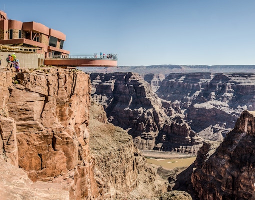 Visitors on the Grand Canyon Skywalk overlooking the canyon's vast landscape.