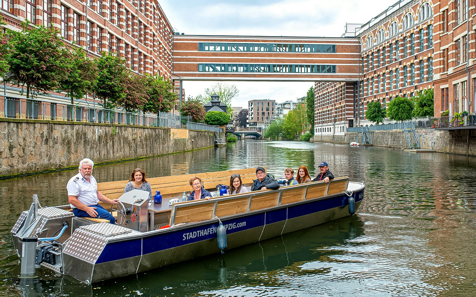 Motorboat tour on Karl Heine Canal, Leipzig, with guests exploring the scenic waterway.