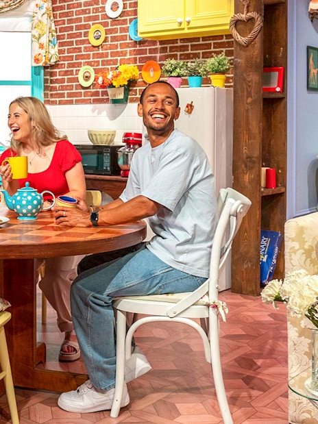 Visitors enjoying The FRIENDS™ Experience set in a colorful kitchen.