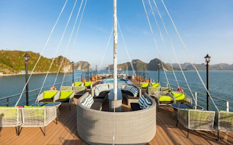 La Casta cruise deck with seating, Ha Long Bay limestone islands in background.