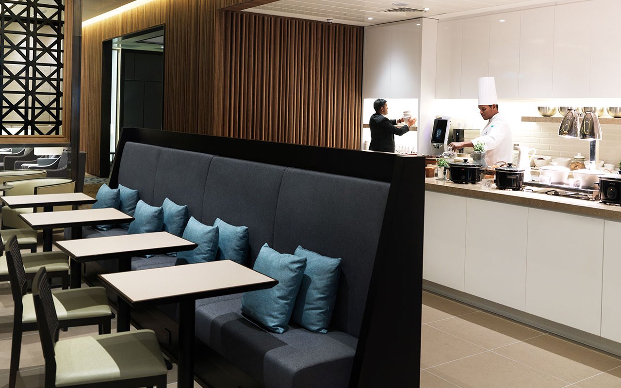 Chef preparing food at Plaza Premium Lounge, London Heathrow Airport.