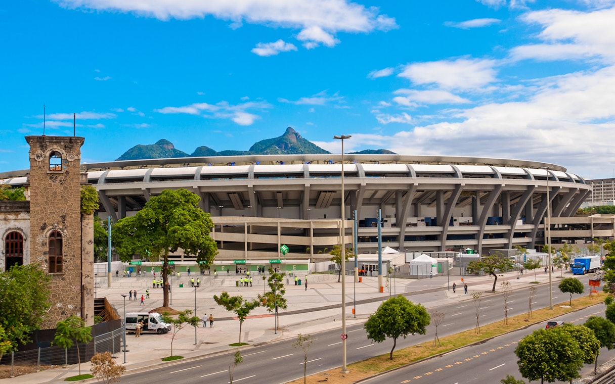 Maracanã Stadium in Rio de Janeiro with distant mountain view.