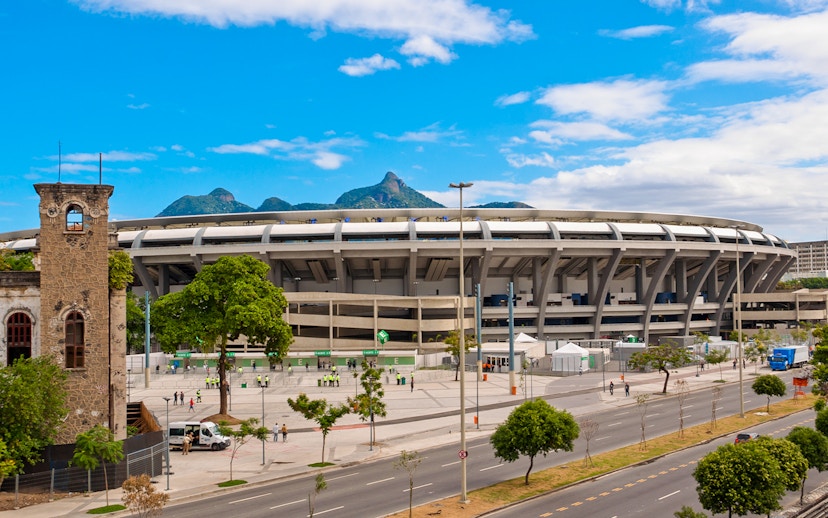 Maracanã Stadium in Rio de Janeiro with distant mountain view.
