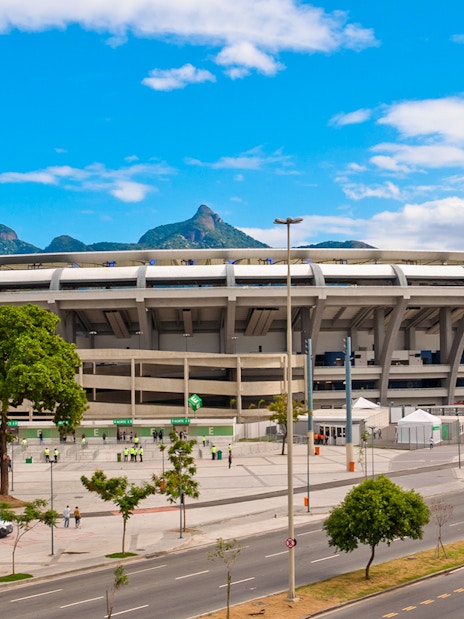 Maracanã Stadium in Rio de Janeiro with distant mountain view.