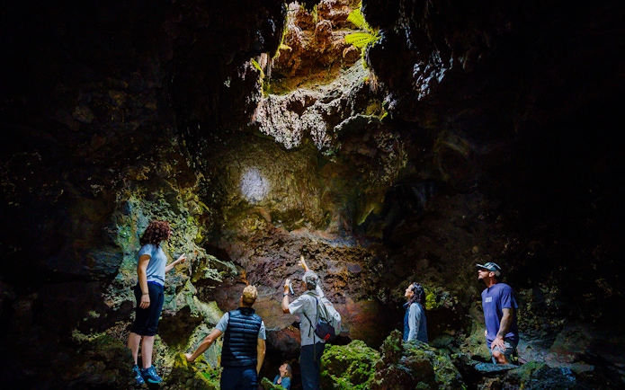 Guests exploring inside Hualalai Volcano on the Hidden Craters Hike.
