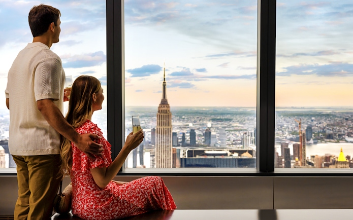 Couple enjoying view of New York City skyline from Edge Observation Deck.