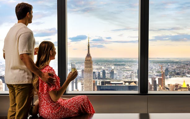 Couple enjoying view of New York City skyline from Edge Observation Deck.