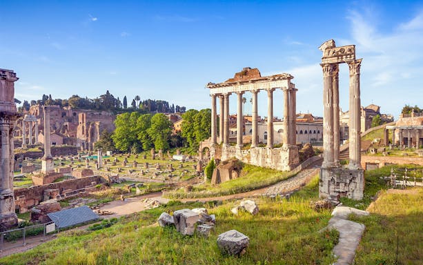 Roman Forum ruins with ancient columns in Rome, Italy.