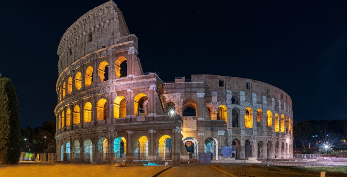 Colosseum illuminated at night during an evening guided tour with arena floor access.