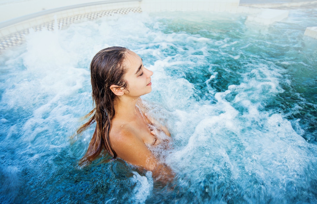 Tourist woman relaxing in a pool.