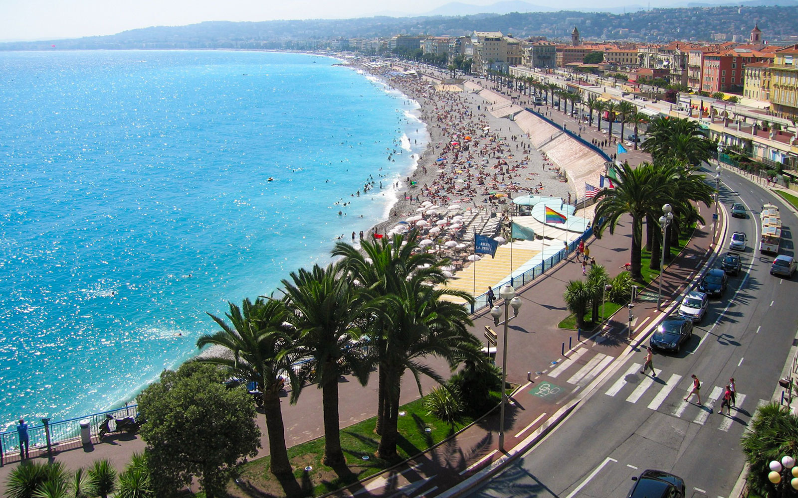 Nice beachfront with promenade and palm trees, part of the Monaco and Nice full-day tour.