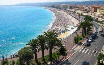 Nice beachfront with promenade and palm trees, part of the Monaco and Nice full-day tour.